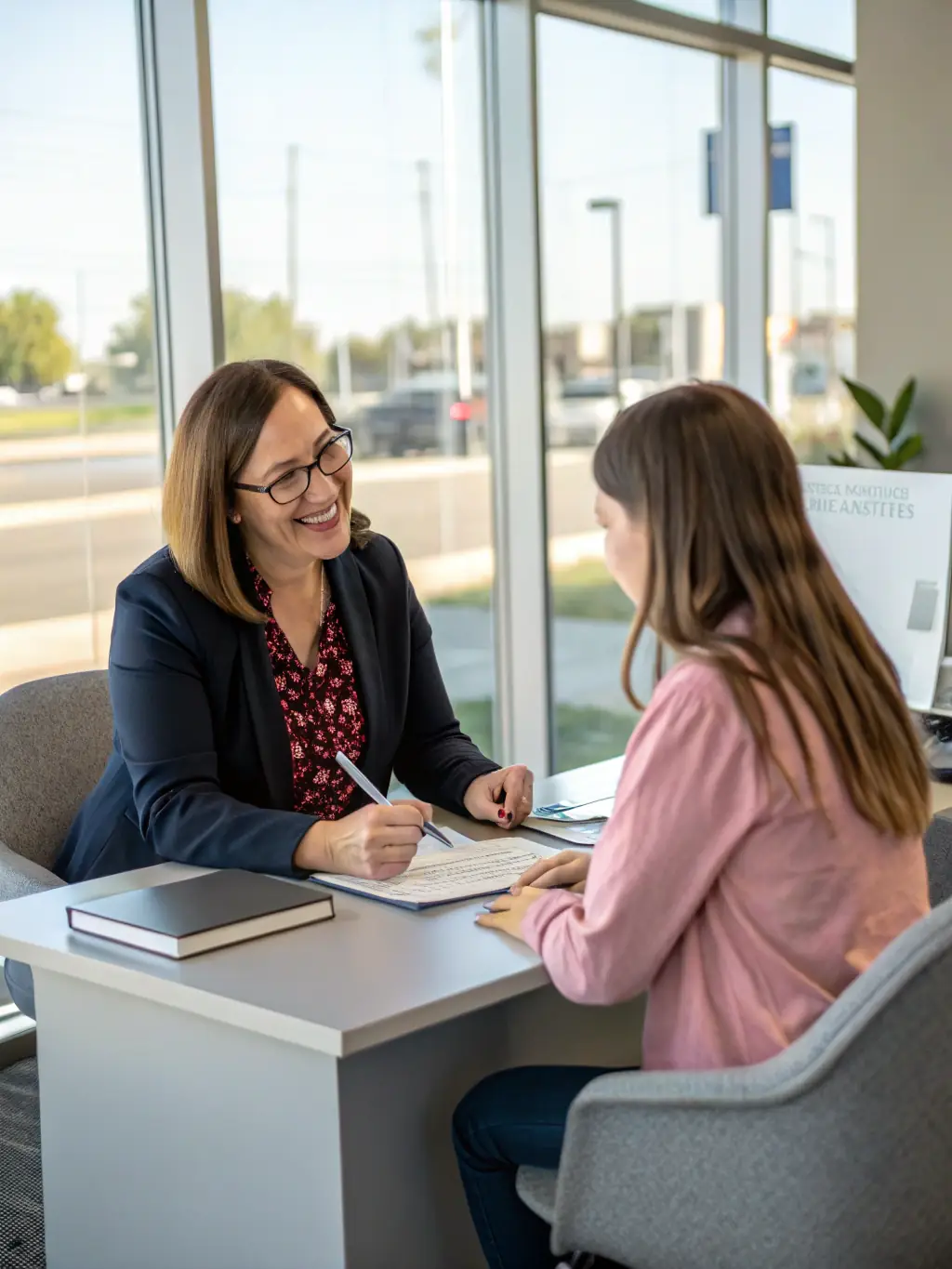 A friendly credit coach sitting with a client, reviewing financial documents and discussing credit improvement strategies.